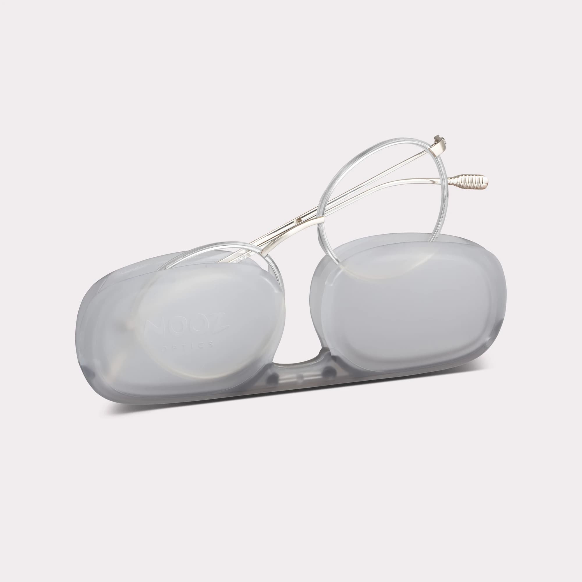 A pair of Ela Crystal Reading glasses coming out of its case
