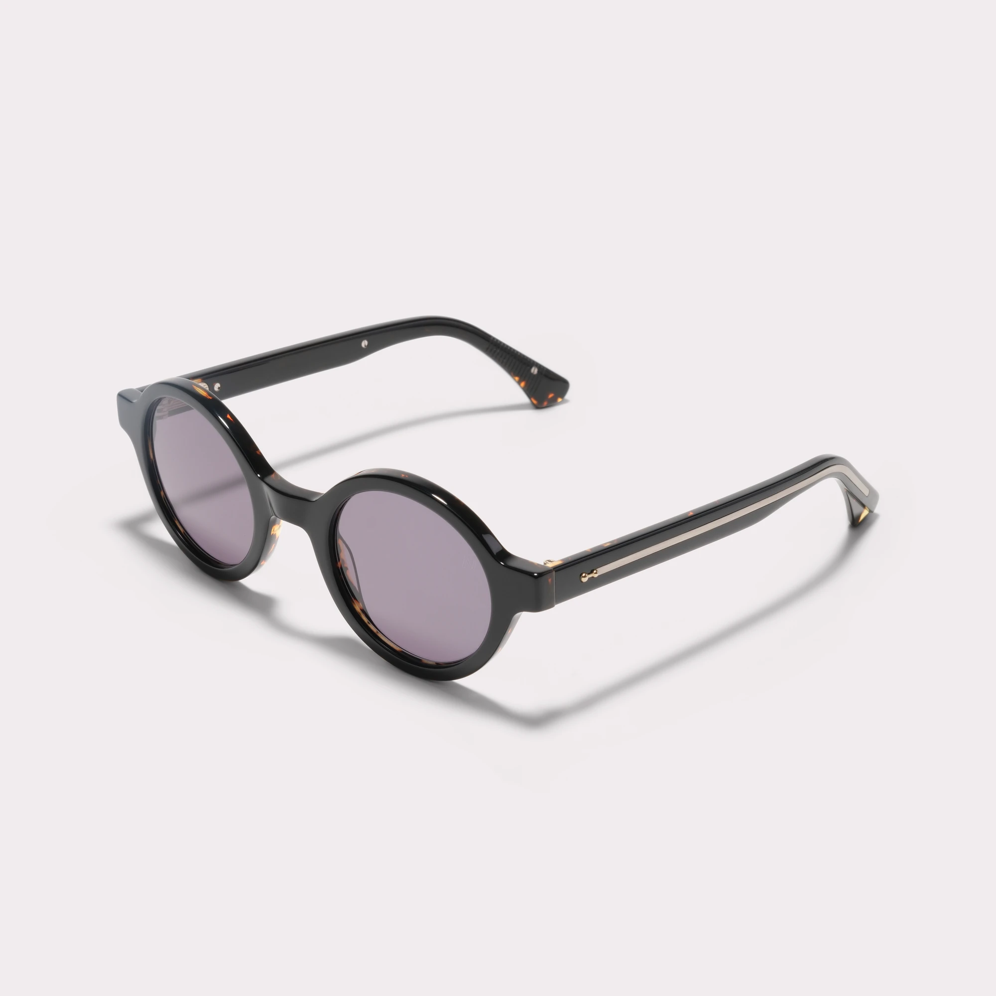 A pair of Nelson Black Sunglasses seen from the side