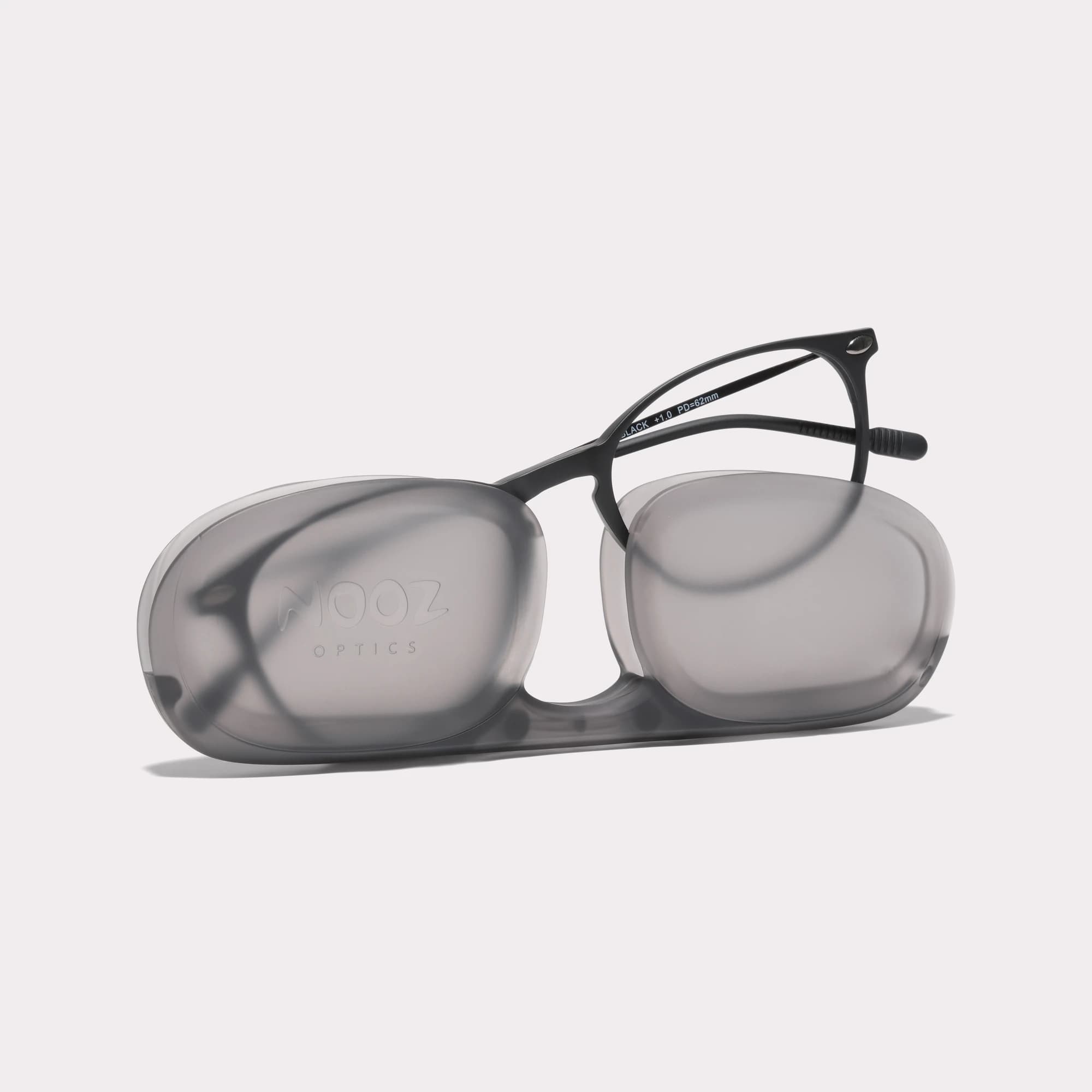 A pair of Alba Black Multi-distance™ reading glasses coming out of its case