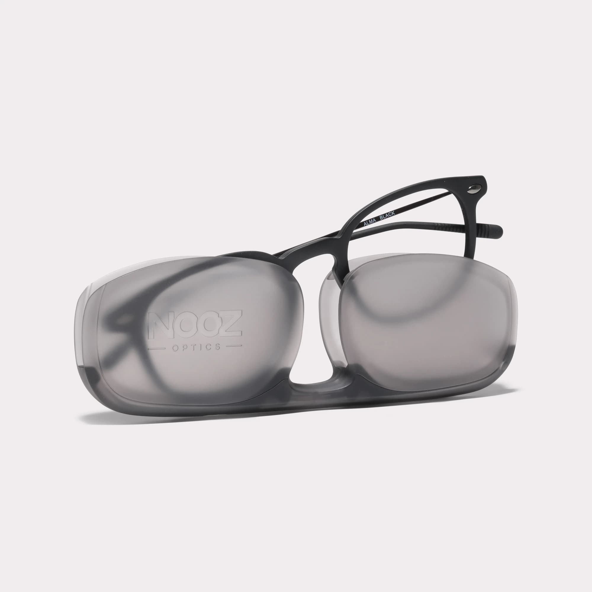 A pair of Alma Black Reading glasses coming out of its case