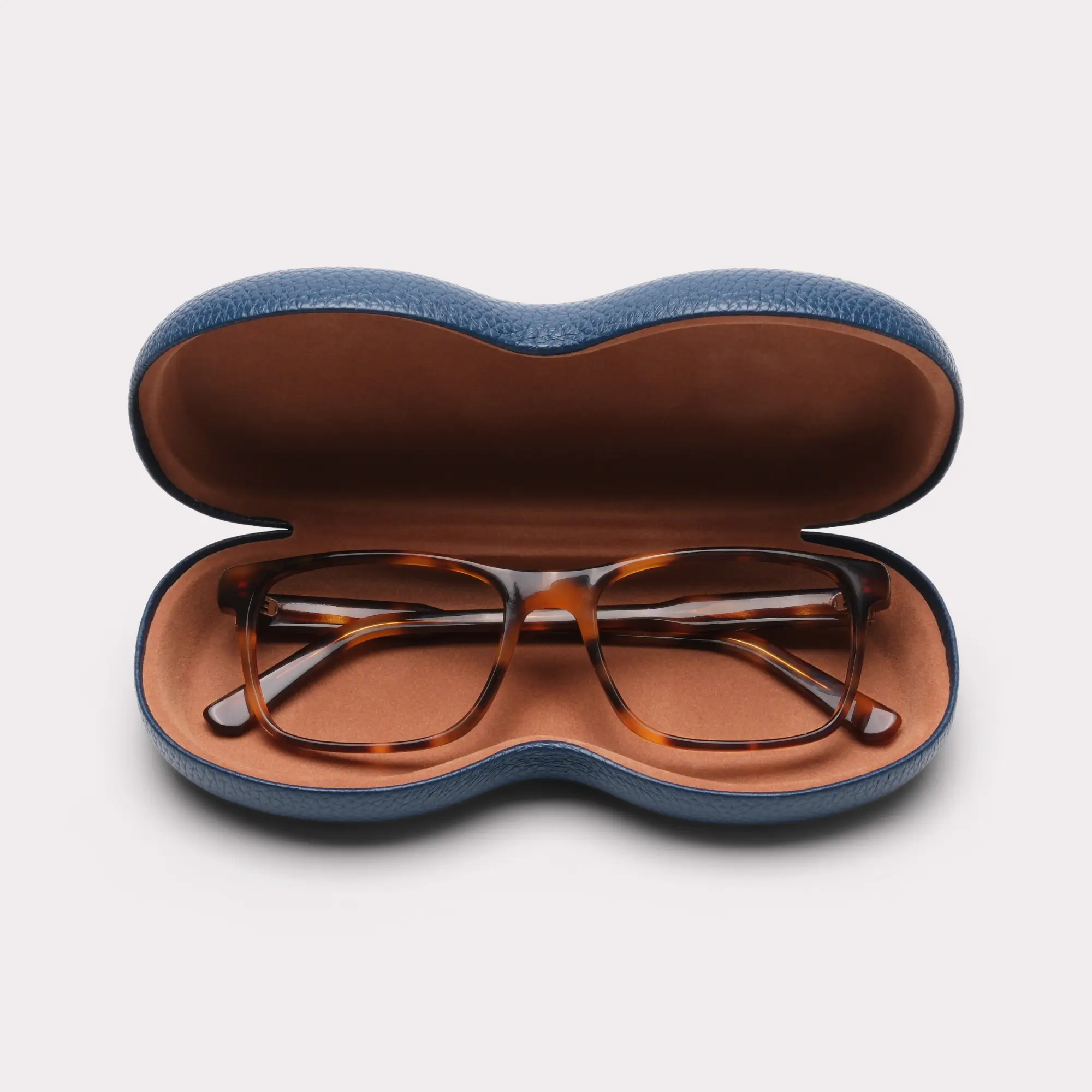 A pair of Justin Tortoise Multi-distance™ blue light blocking reading glasses coming out of its case