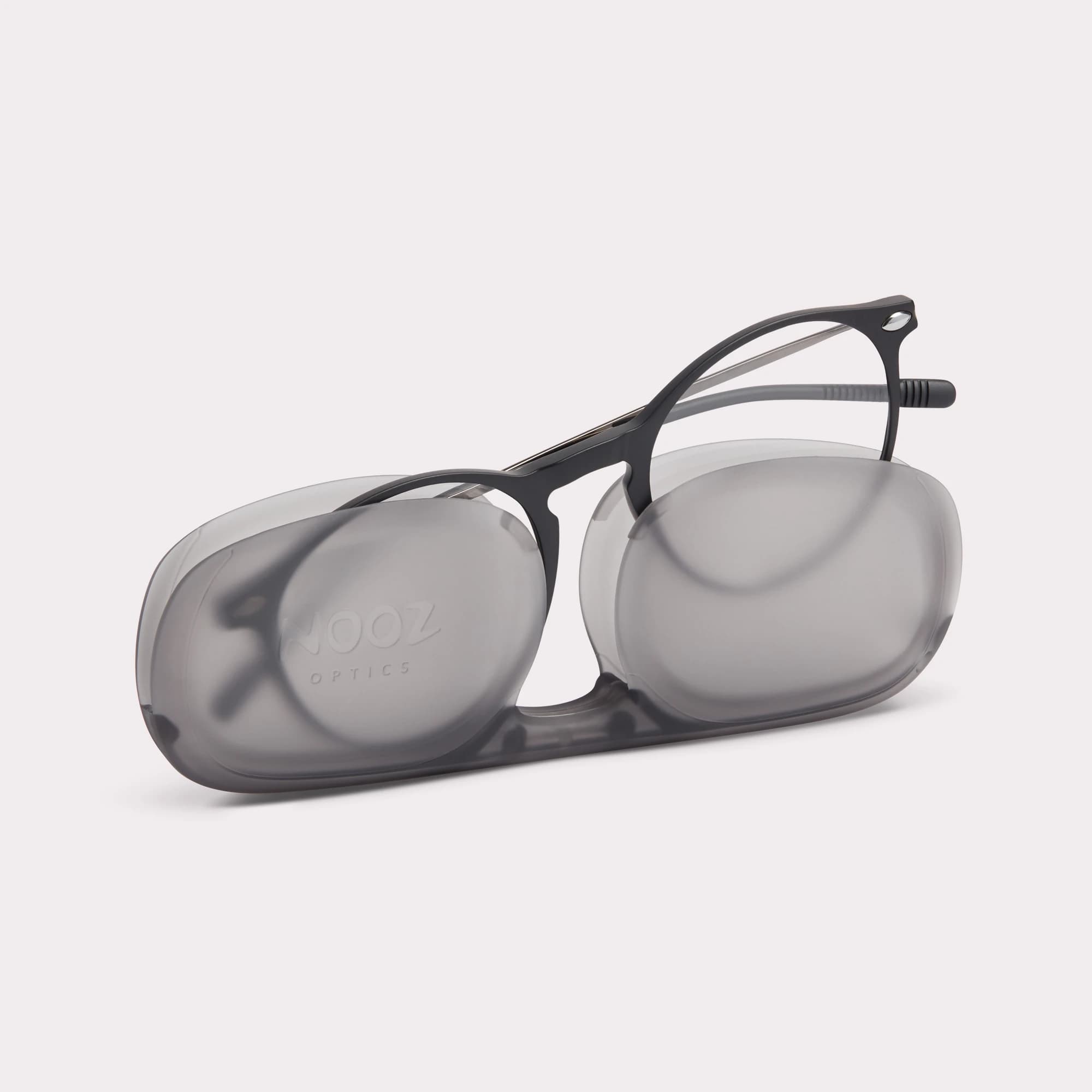 A pair of Cruz Black Reading glasses coming out of its case
