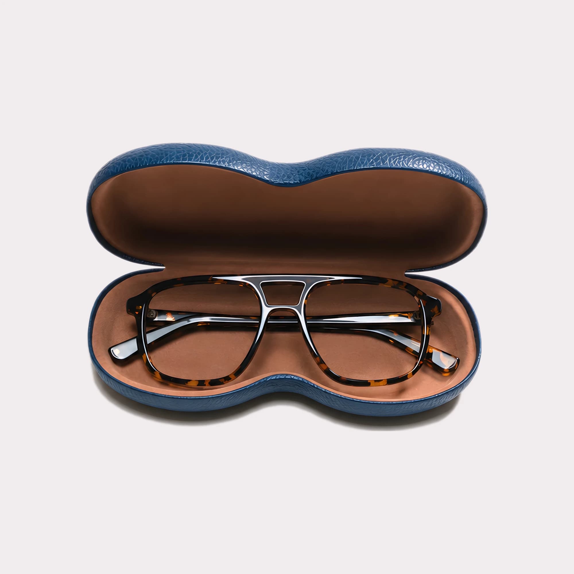 A pair of Milen Yellow tortoise Multi-distance™ blue light blocking reading glasses coming out of its case