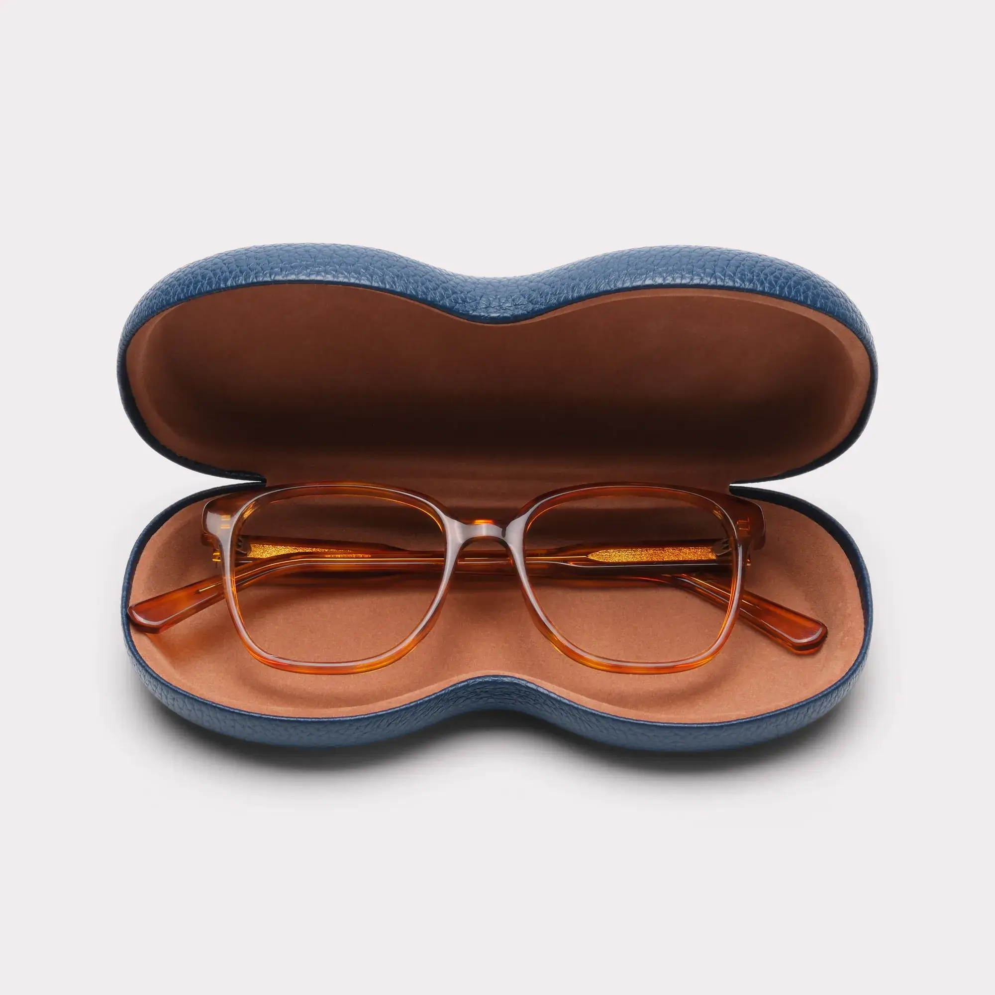 A pair of Clara Light tortoise Reading glasses coming out of its case