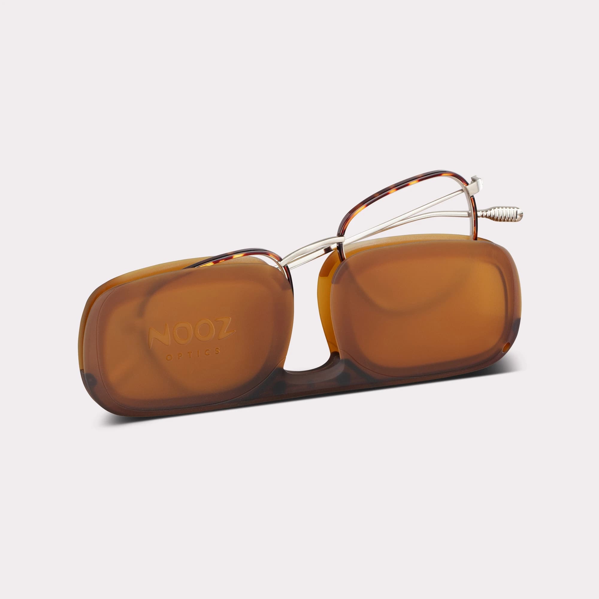 A pair of Hiro Tortoise Reading glasses coming out of its case