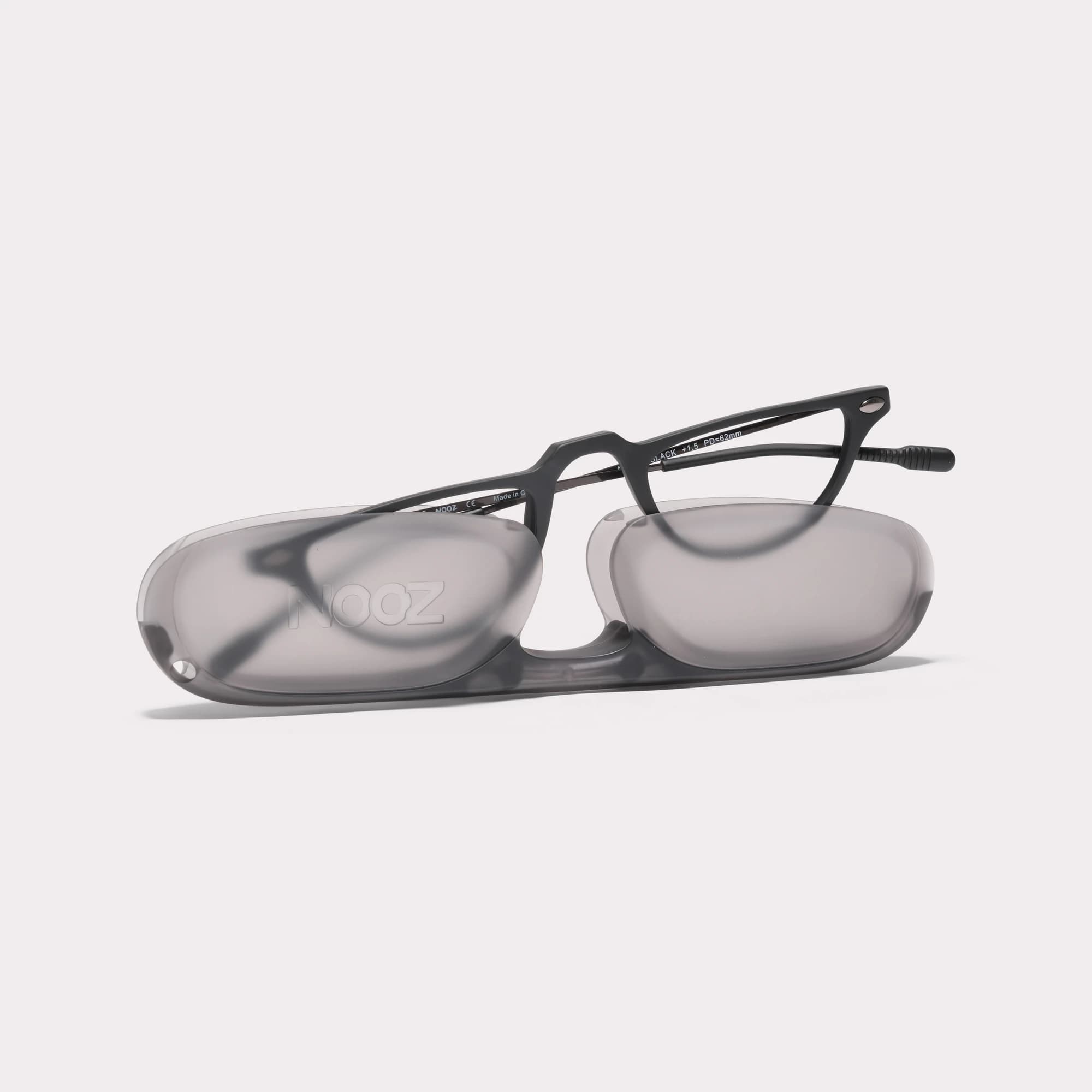 A pair of Moon Black Reading glasses coming out of its case