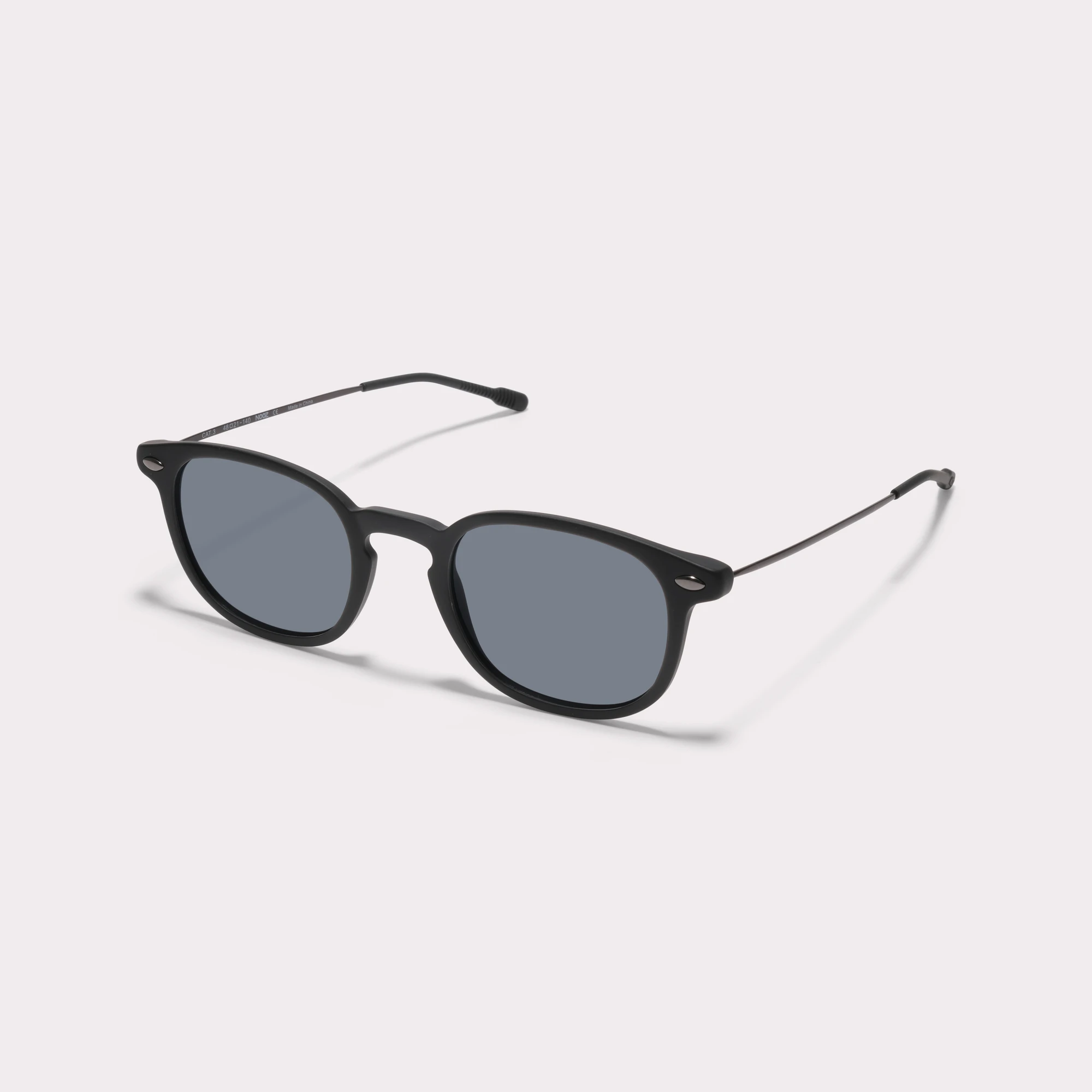 A pair of Alma Black Sunglasses seen from the side