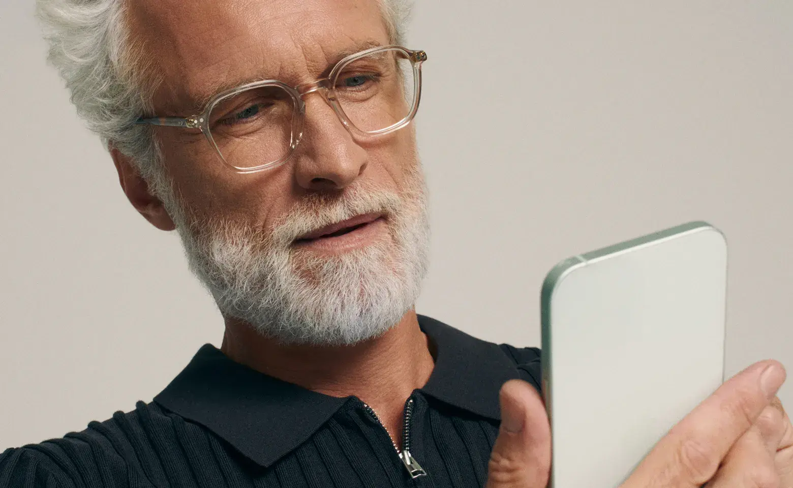 Man reading on his phone with Multi-Distance glasses